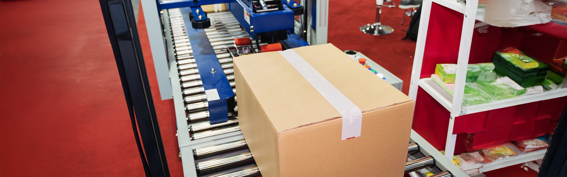Carton packaging system moving sealed cartons on a conveyor to improve product safety and handling during packaging operations.