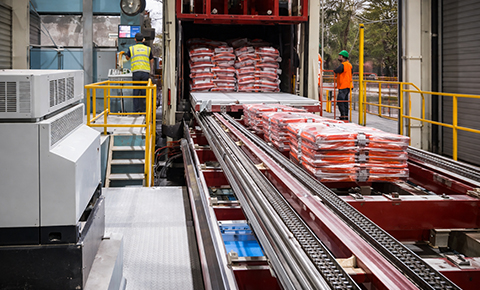 automatic truck loading systems used for fast and efficient loading of packaged goods in industrial warehouses