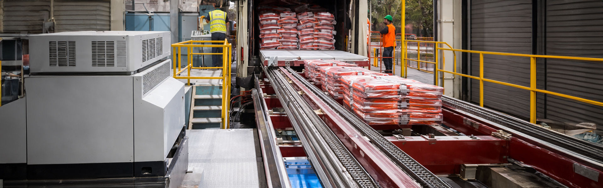 automatic truck loading system transferring palletized bags into a truck for faster warehouse loading