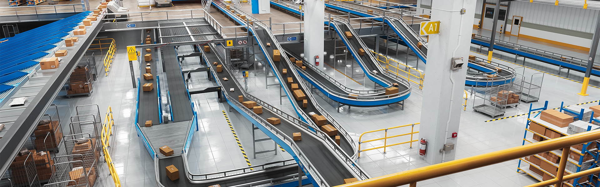 Industrial conveyor system used in automated end-of-line packaging operations in a manufacturing facility