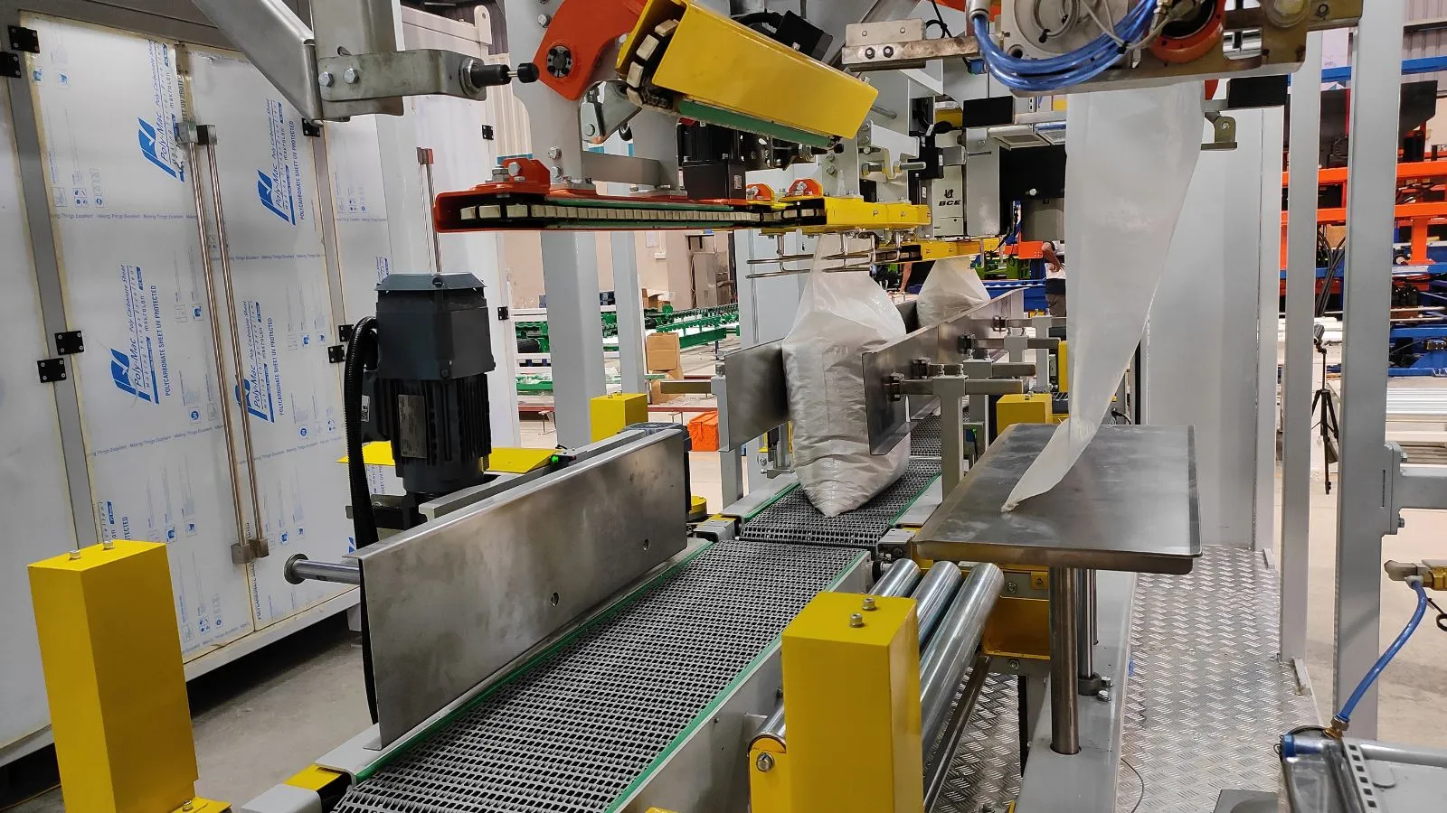Automatic big bag filling machine handling bulk bags on a conveyor line for faster and safer industrial packaging